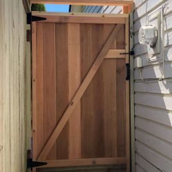 new cedar gate installed with black hinges and latch